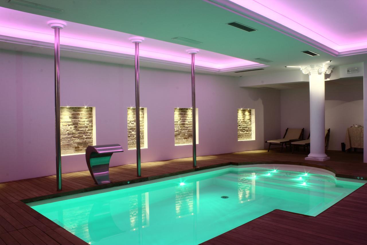 Hotel Vittoria Pesaro Exterior photo A swimming pool with LED lighting